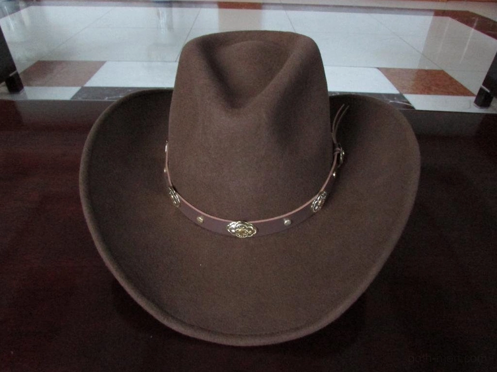 Brown gothic cowboy hat front oblique view showing solid brown color, embossed metal leather band, and full brim width