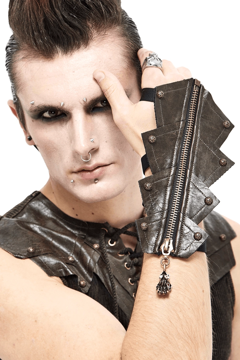 Male model wearing brown leather fingerless gloves with skull zipper detail and studded panels, gothic punk styling