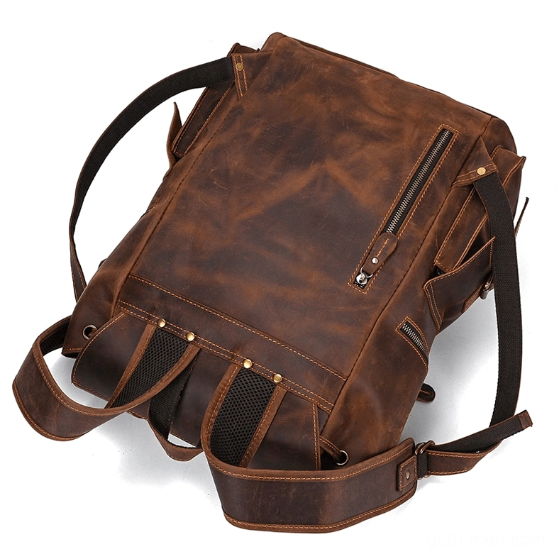Brown genuine leather gothic backpack with convertible carry straps and side zipper pocket - side oblique view