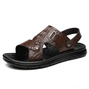 Brown genuine leather sandals with crocodile embossing and adjustable heel buckle closure, three-quarter angle detail shot
