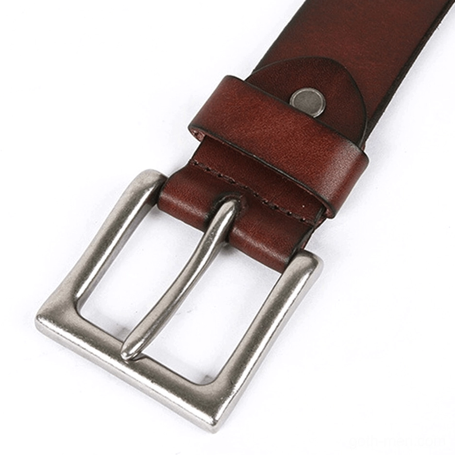 Dark brown leather belt with large rectangular silver buckle and rivet embellishments close-up