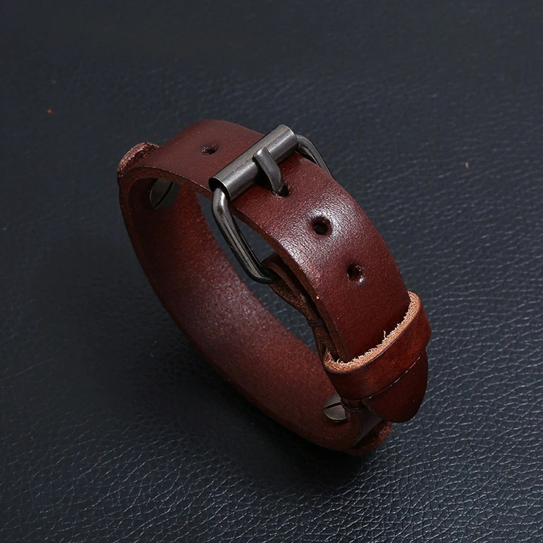Dark brown genuine leather gothic cuff bracelet showing adjustable holes and antique silver buckle closure mechanism