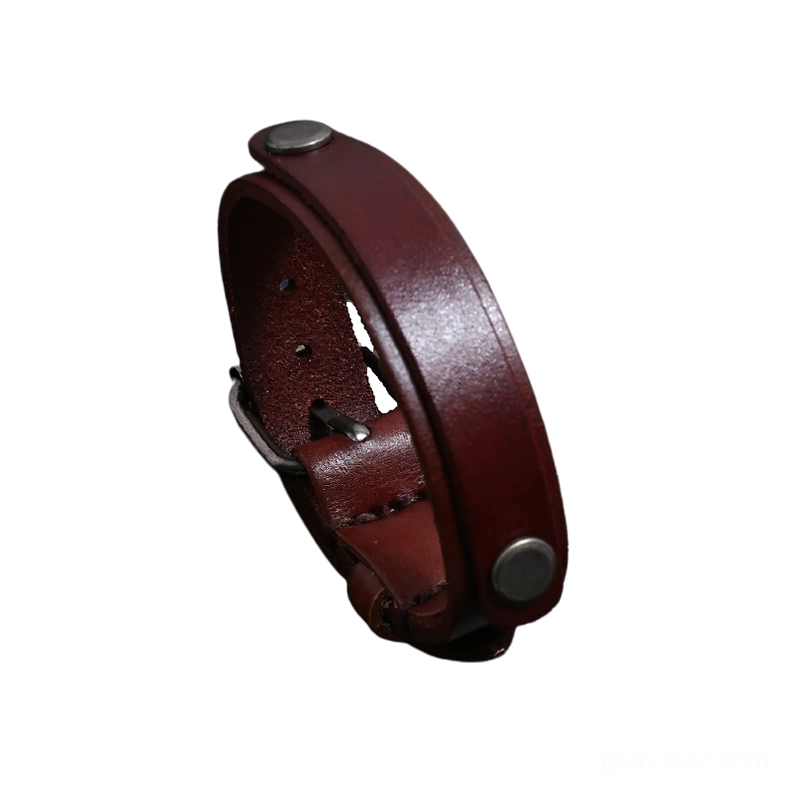 Dark brown genuine leather gothic cuff bracelet with metal hardware, side profile view on black background