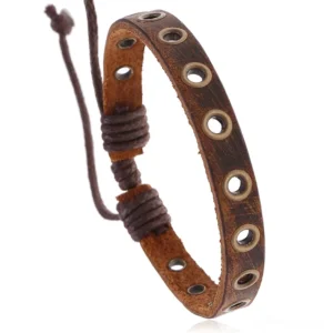 Distressed brown leather gothic bracelet with metal grommet eyelets, top-down close-up view