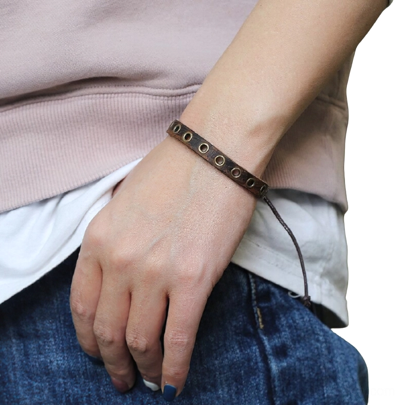 Adjustable vintage brown leather bracelet on female wrist showing side profile and pull-tie closure