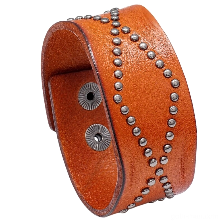 Brown vintage cowhide gothic cuff bracelet with cross rivet embellishment, oblique top view