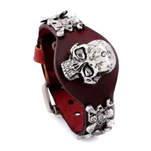 Dark brown genuine leather skull cuff bracelet with antique silver-plated skull and crossbone ornament, displayed from oblique side angle