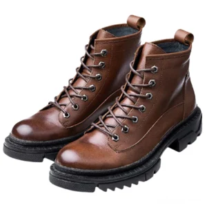 Pair of brown vintage leather gothic combat boots with round toe and industrial rubber sole - front view