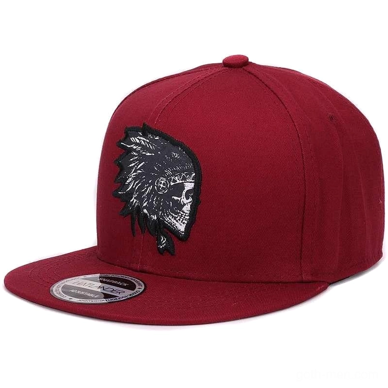 Burgundy gothic snapback cap with black embroidered skull feather motif, side profile showcasing flat brim