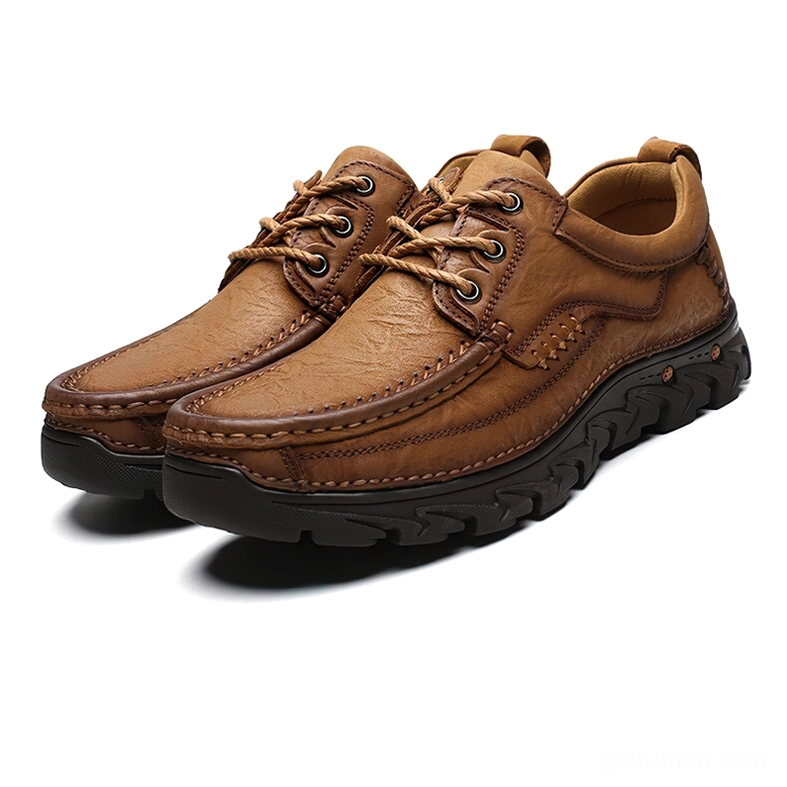 Pair of tan camel leather lace-up gothic oxford shoes with crafted stitching