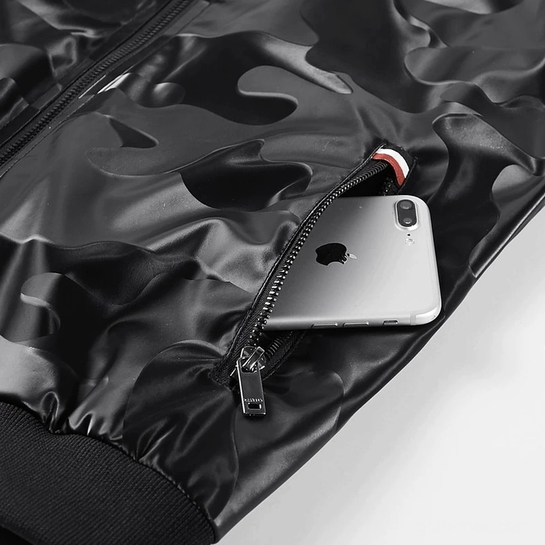 Close-up detail of camouflage PU leather bomber jacket side zipper pocket with red-white trim, smartphone storage capacity demonstrated