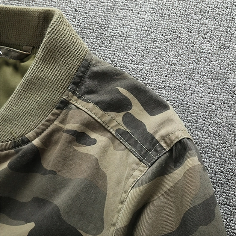 Shoulder and collar close-up of camo denim jacket showing neat stitching, durable camouflage fabric and ribbed collar trim