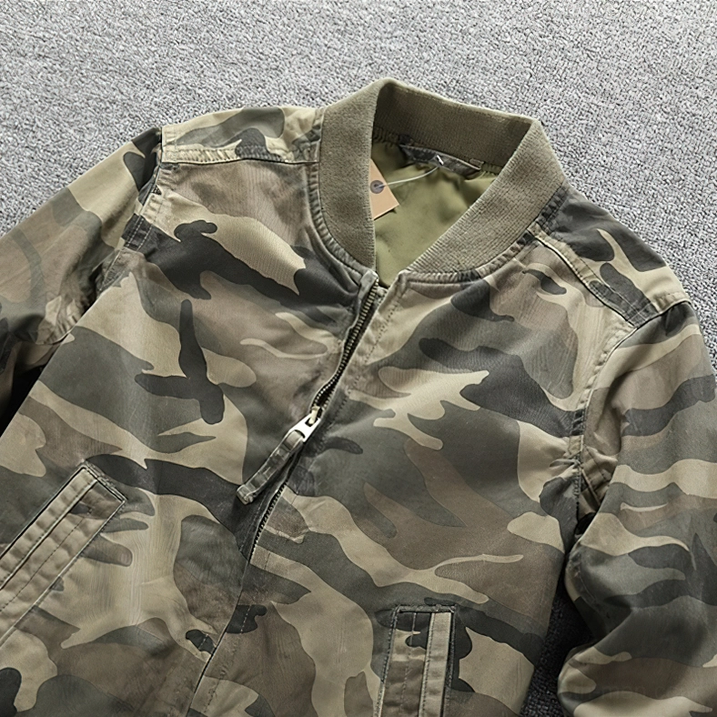 Camo denim zip jacket side view detail, canvas camouflage fabric texture with metal zipper and ribbed collar trim
