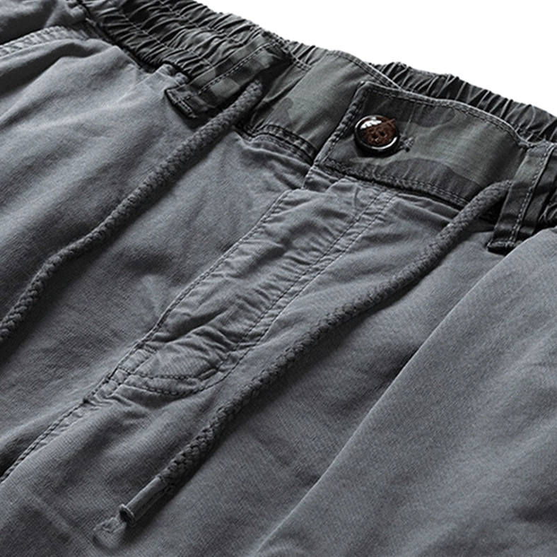 Close-up waist detail of gothic cargo joggers showing elastic waistband drawstring button