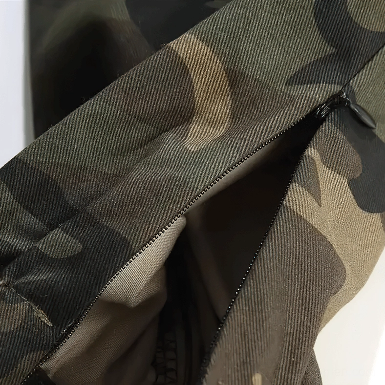 Hidden zipper closure on camouflage cargo pants pocket with interior visible