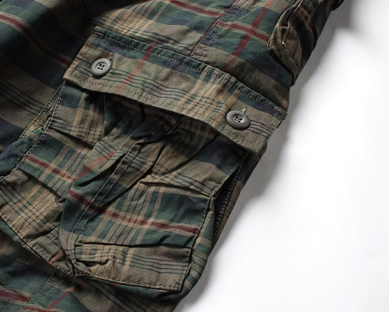 Close-up of button-flap cargo pocket construction on tartan plaid shorts