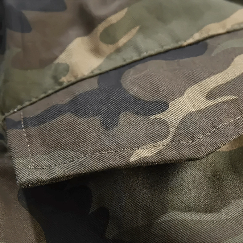 Cargo pocket flap reinforced stitching and construction detail on camouflage twill