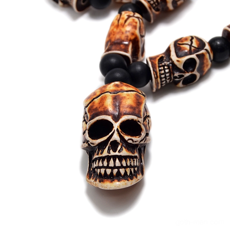 Close-up tan skull pendant detailed carved gothic necklace focal point