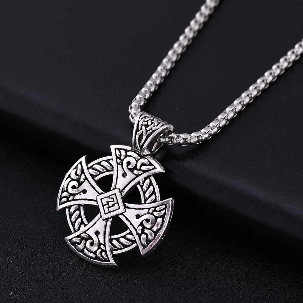 Celtic cross pendant with central square knot detail, antique silver finish with wheat link silver chain on dark background