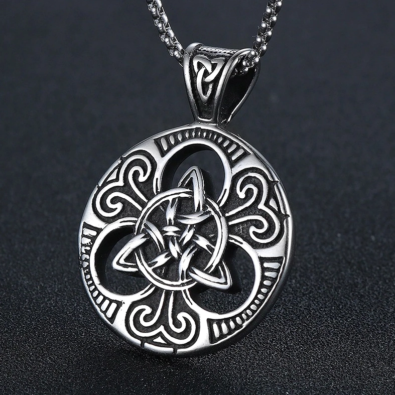 Celtic knot cross shield pendant polished silver front flat lay dark background