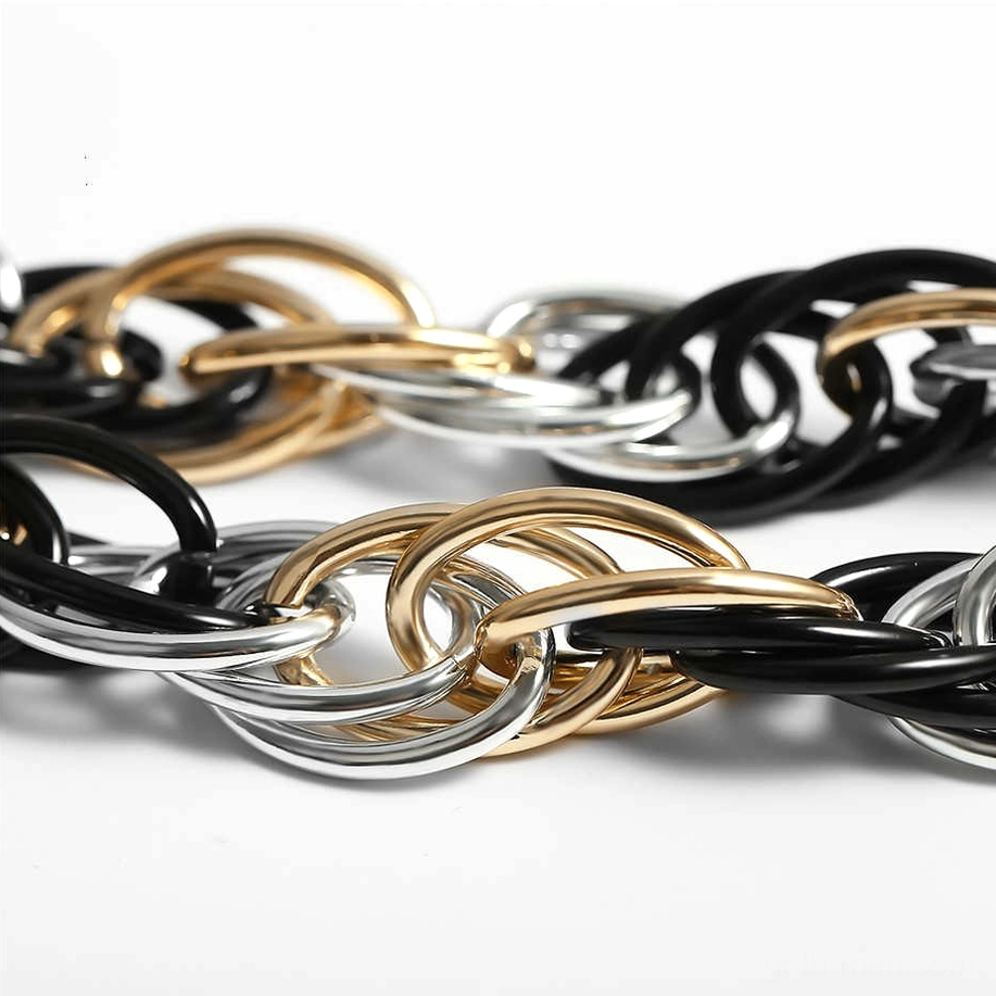 Overhead view of chunky overlapping tri-color chain links creating geometric pattern
