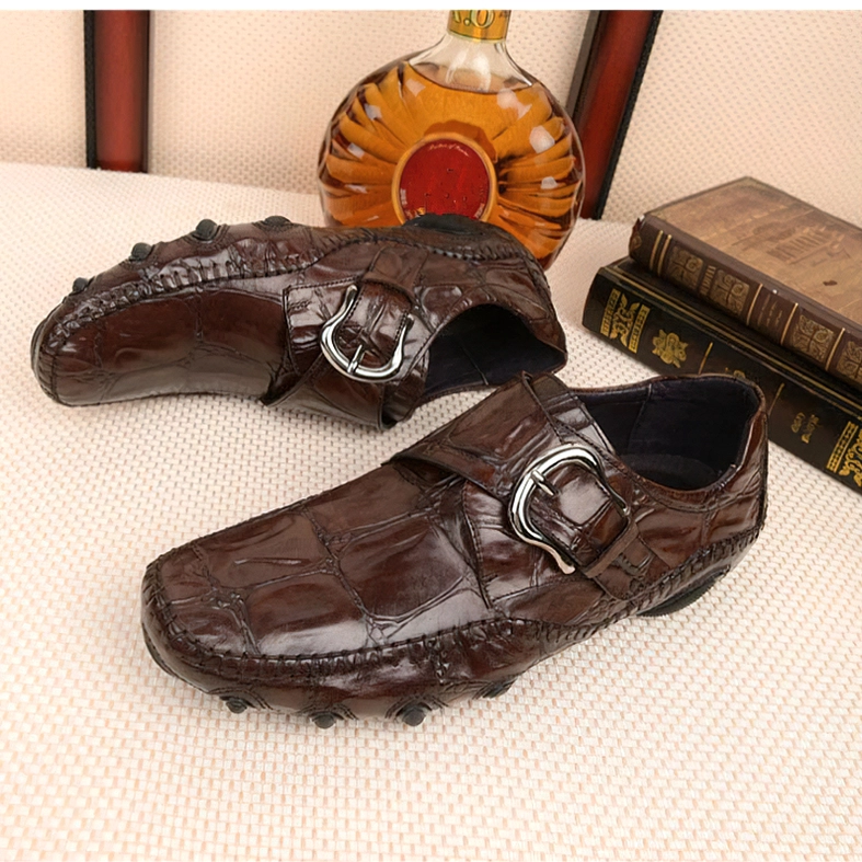 Coffee brown gothic crocodile loafers close-up detail of metal buckle hardware and leather texture