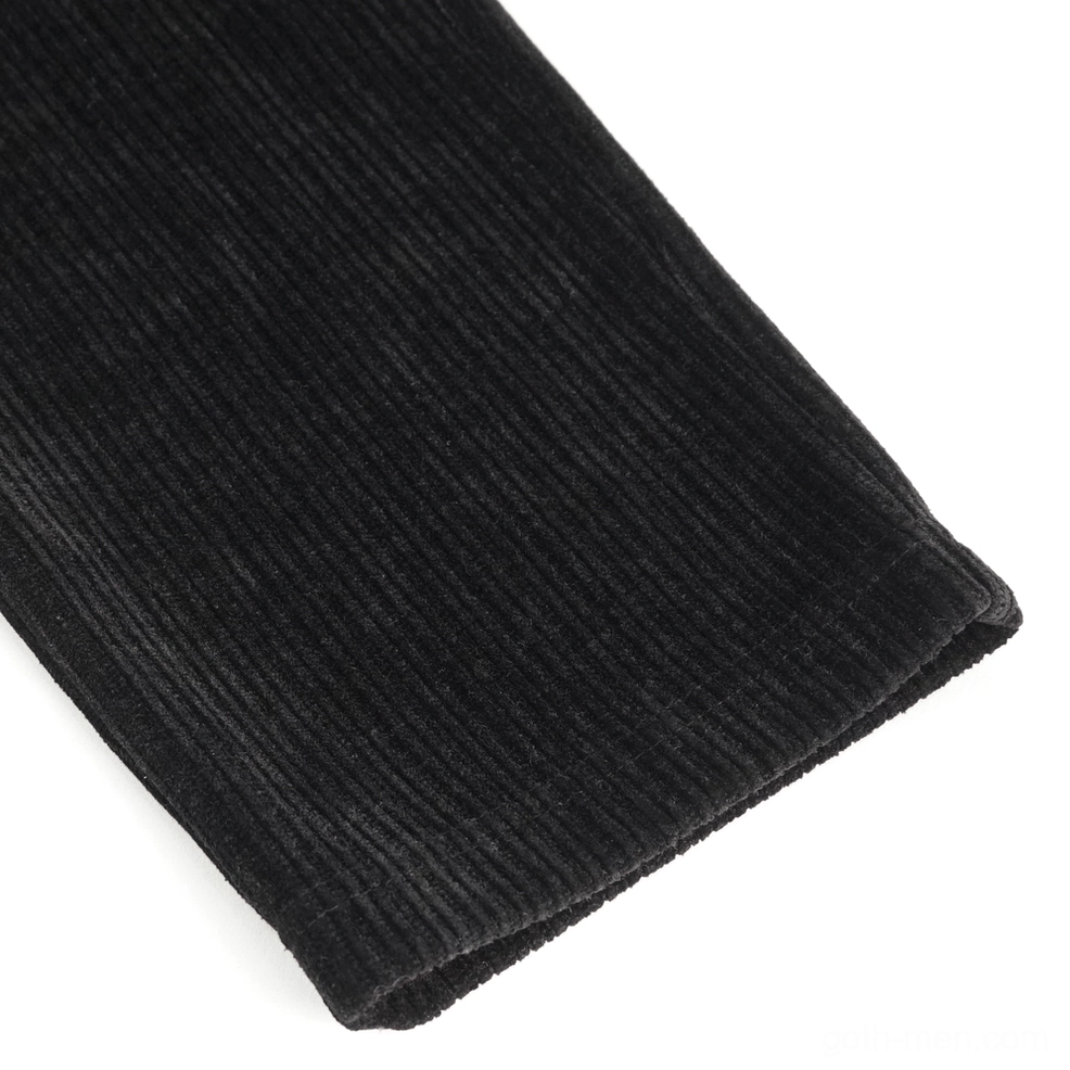 Close-up flat lay of ribbed black corduroy fabric texture showing quality of heavyweight material