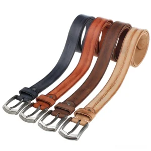 Collection of handcrafted cowhide gothic belts with antique alloy buckles in multiple vintage colors including deep brown, forest green, and burnt orange on white studio background