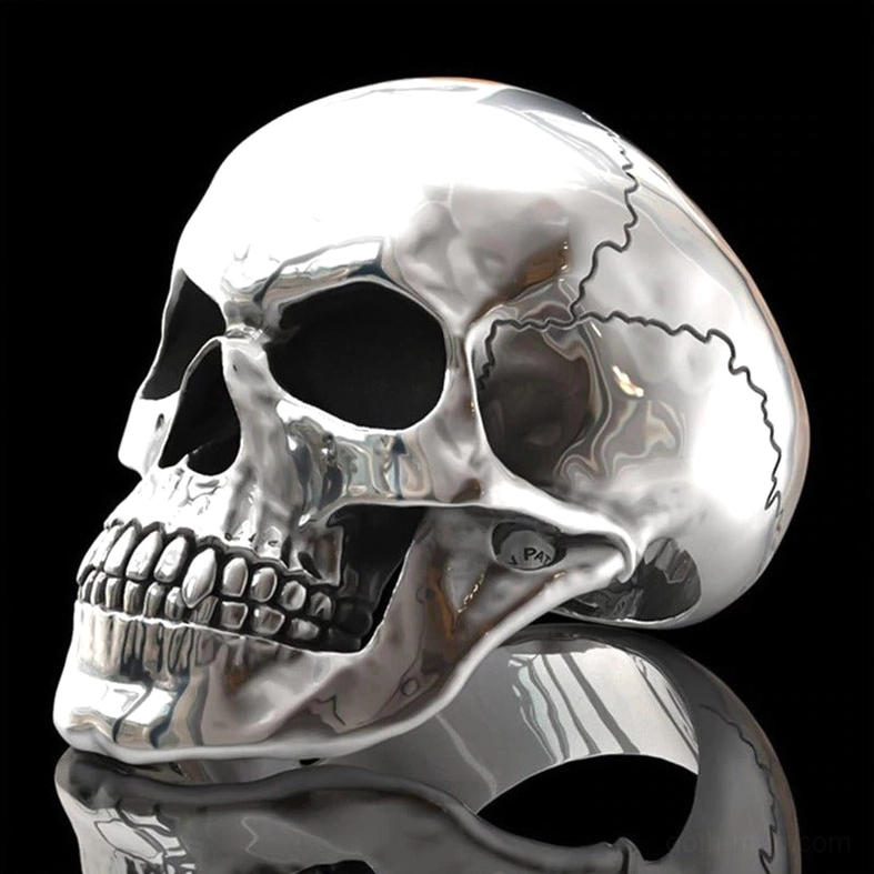 Skull ring side view with reflective black background highlighting polished silver finish and cracked texture