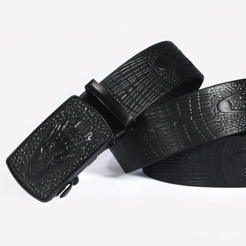 Rolled crocodile leather belt with matte black automatic buckle, oblique side angle showing rolled strap construction