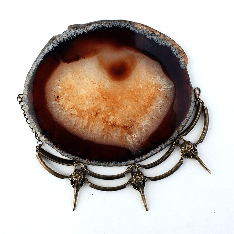 Gothic crow skull bracelet paired with natural agate stone displaying mystical witch aesthetic and antique metal finish