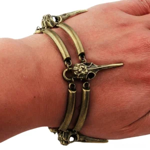 Double layer crow skull bracelet worn on wrist showing side profile of gothic witch jewelry with bird skull charms