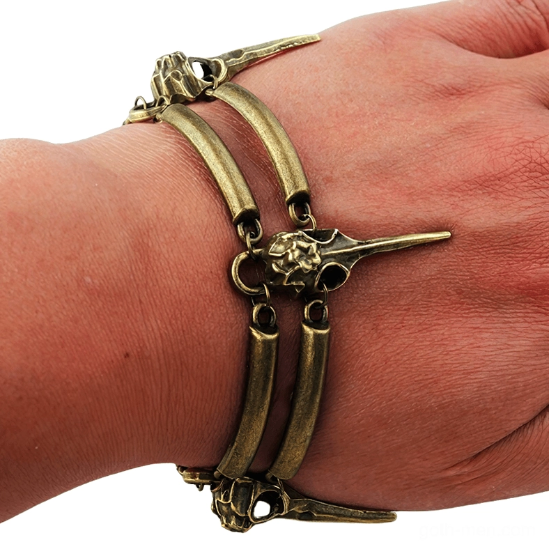 Double layer crow skull bracelet worn on wrist showing side profile of gothic witch jewelry with bird skull charms