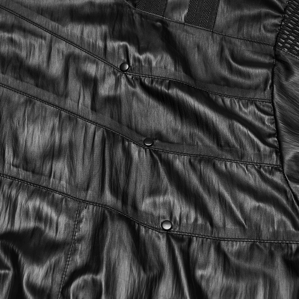 Jacket seam and metal snap fastener close-up showing construction quality