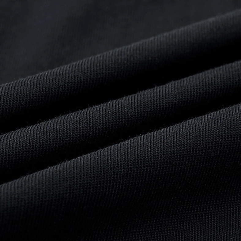 Dense cotton knit fabric texture close-up on black patchwork gothic t-shirt