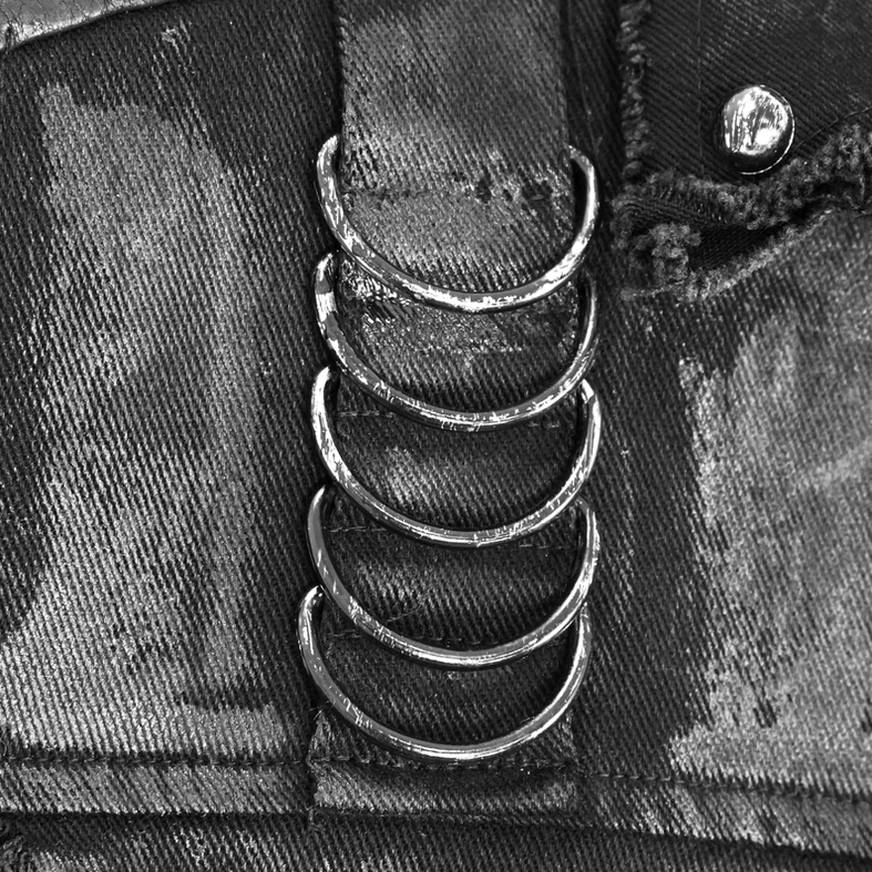 Front detail of multiple metal D-rings and snap fastener hardware on black gothic waistcoat