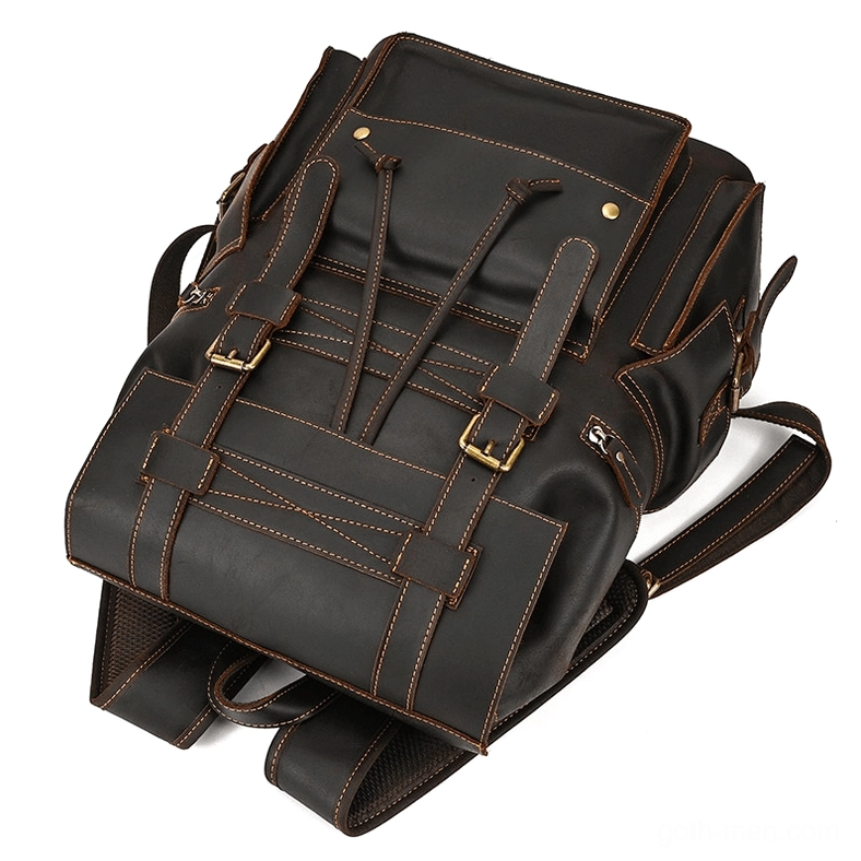 Dark brown leather gothic backpack showing industrial hardware and rivet reinforcements detail
