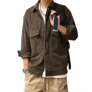 Dark brown waffle cord oversized gothic cargo shirt front view on male model, displaying full-length sleeves, button closure, and structured cargo pockets for alternative fashion styling