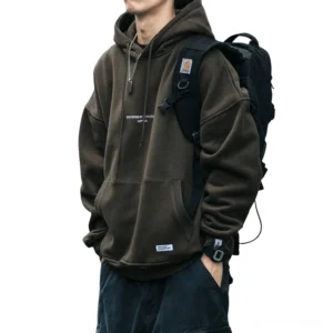 Army green gothic hoodie worn by male model with backpack and accessories, outdoor alternative streetwear styling