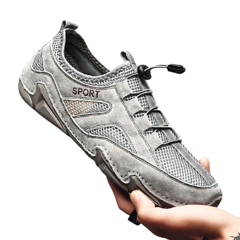 Dark grey leather and mesh gothic sneaker held in hand - left profile with suede details