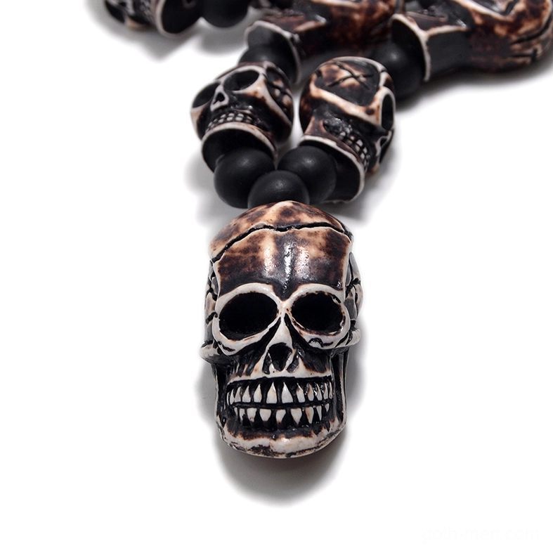 Close-up dark aged skull pendant sharp carved details gothic jewelry