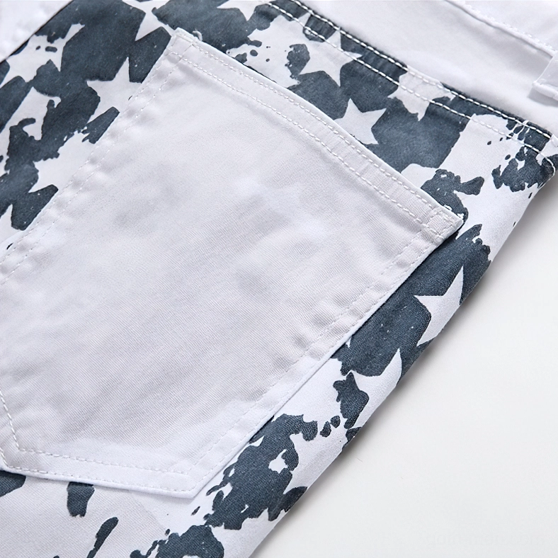 Detailed view of structured white back pocket with star-printed fabric and reinforced seams on gothic denim jeans