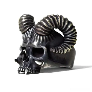 Gothic horned skull ring left three-quarter angle showing textured spiral horns and lower jaw fangs