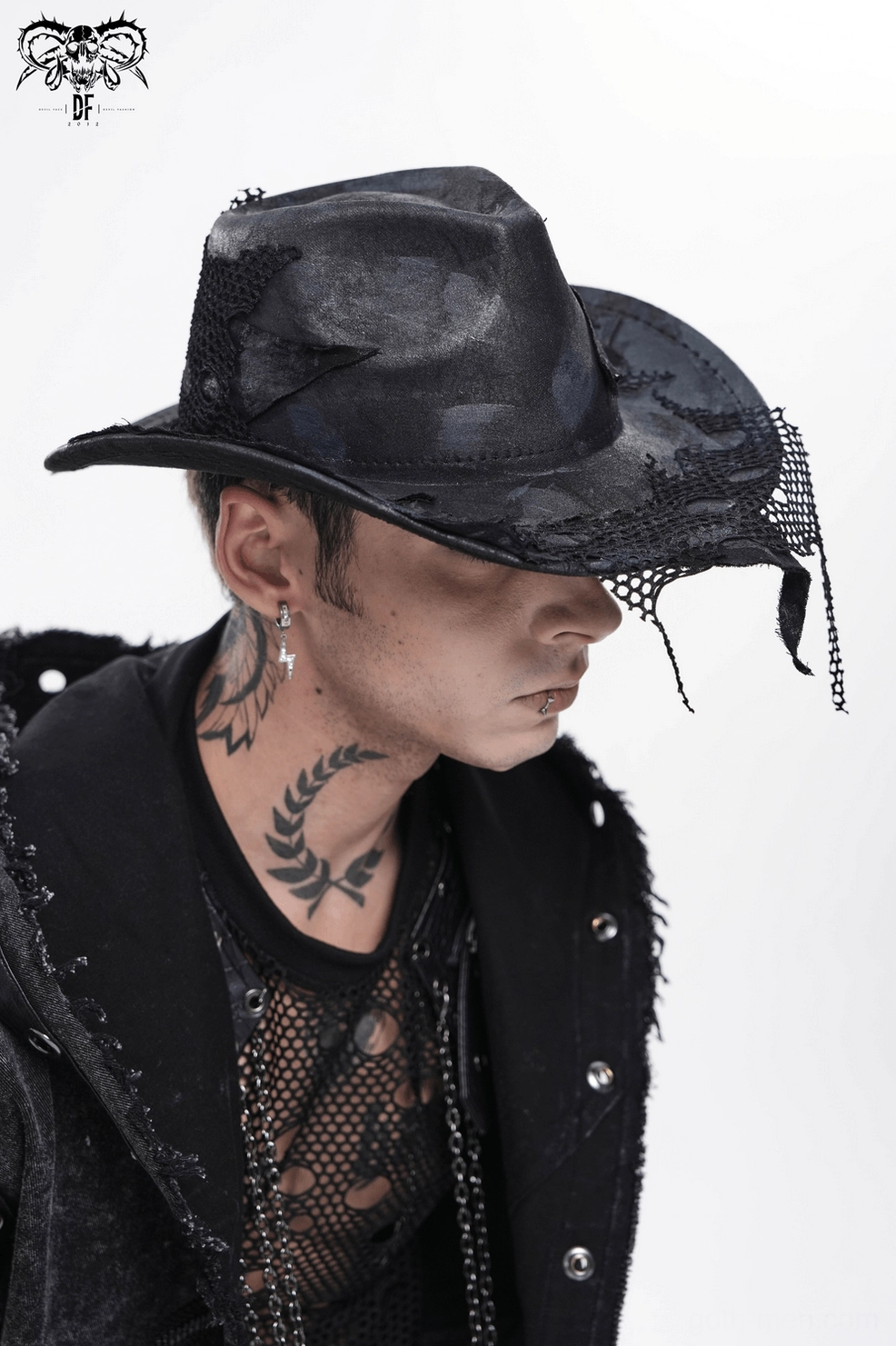 Distressed black cowboy hat detail showcasing fishnet mesh patches and hand-crafted darkwear finish
