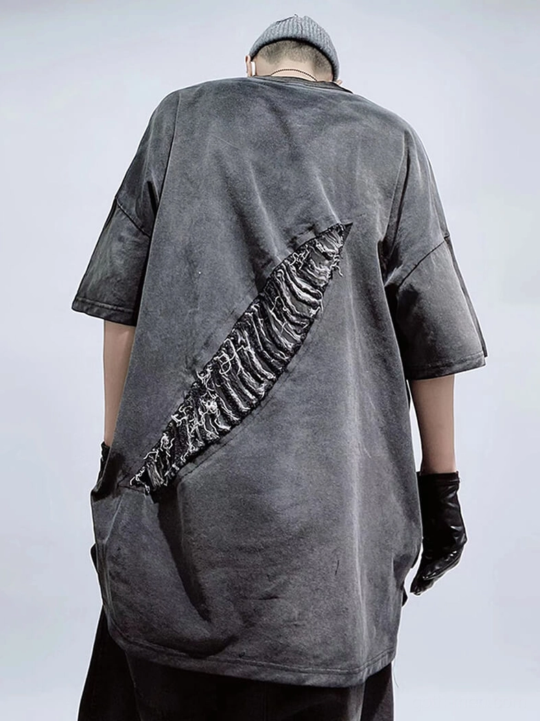 Dark gray oversized distressed T-shirt rear three-quarter view showcasing back ripped patch design detail