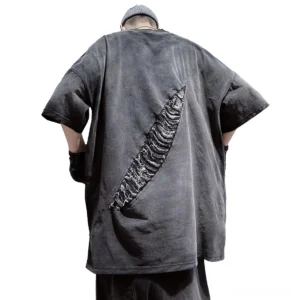 Dark gray distressed grunge T-shirt rear full view showing back diagonal ripped patch details, oversized fit