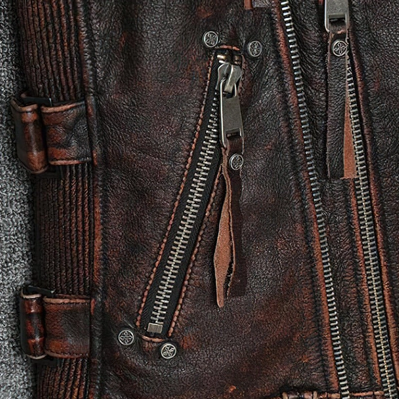Close-up of distressed leather texture on vintage brown gothic biker vest aging patina