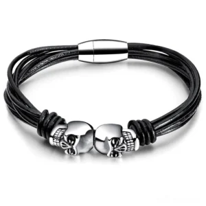 Double skull stainless steel gothic bracelet flat lay on white background, showing intricate rope chain and silver skull charms
