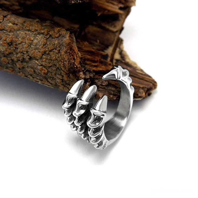Dragon claw open band ring right front view on dark wood bark background emphasizing open claw structure