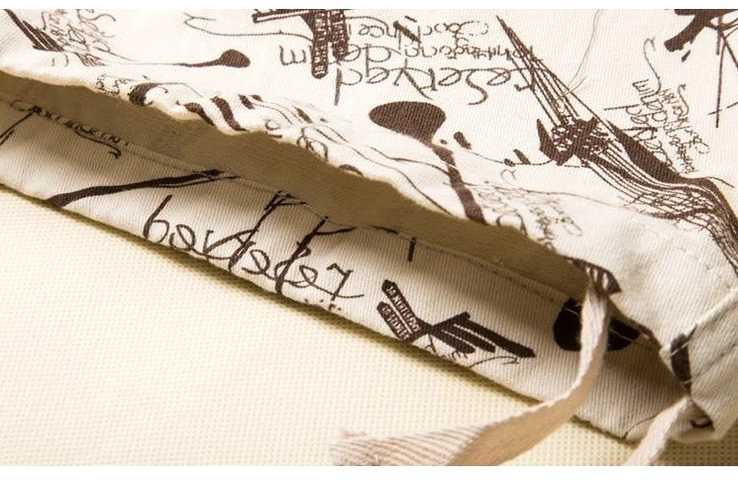 Drawstring hem and inner waistband detail on graffiti gothic cargo shorts, side close-up view